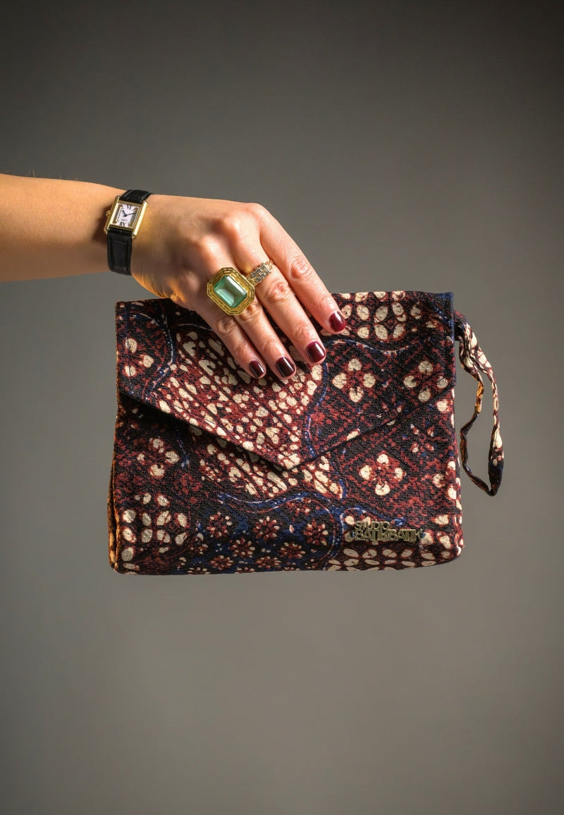 Blue brown batk clutch hold by a woman
