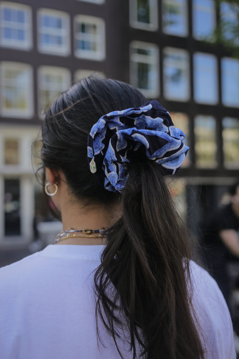 Mega mendung blue large scrunchie in straig brown hair.