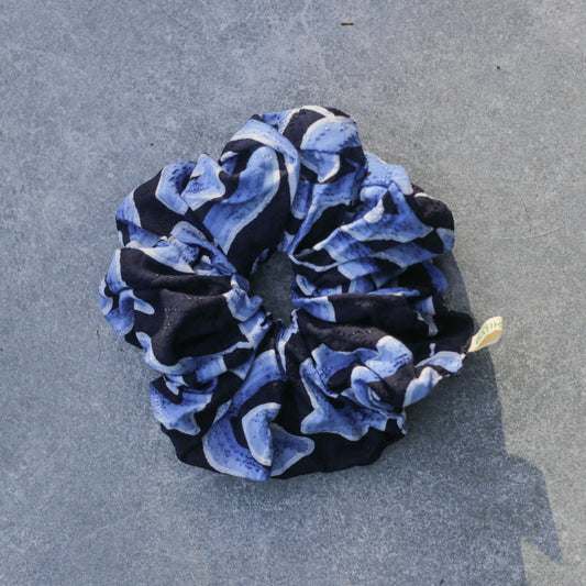 Blue and black patterned Batik scrunchie on a gray surface
