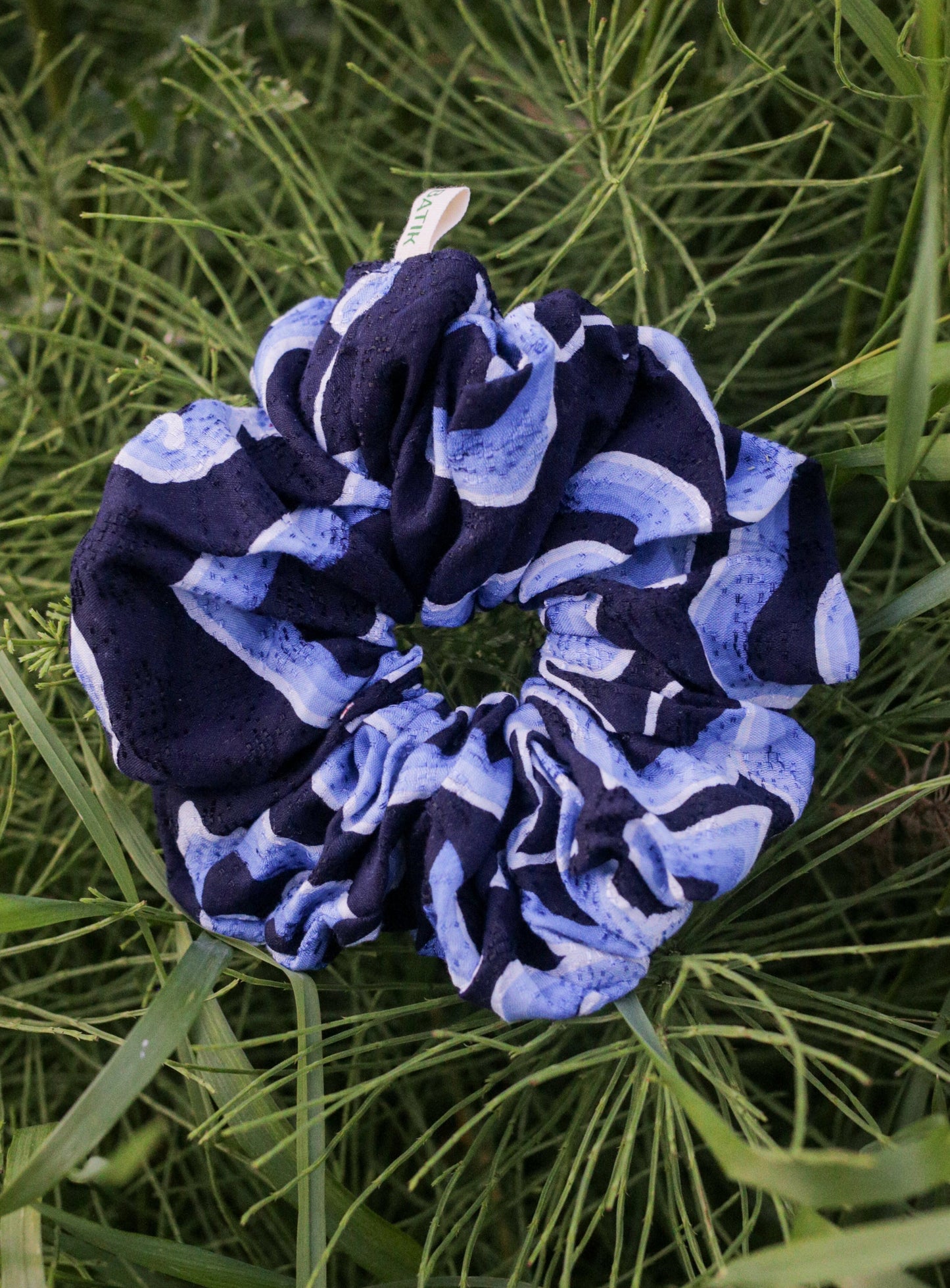 Navy and light blue batik scrunchie on green grass