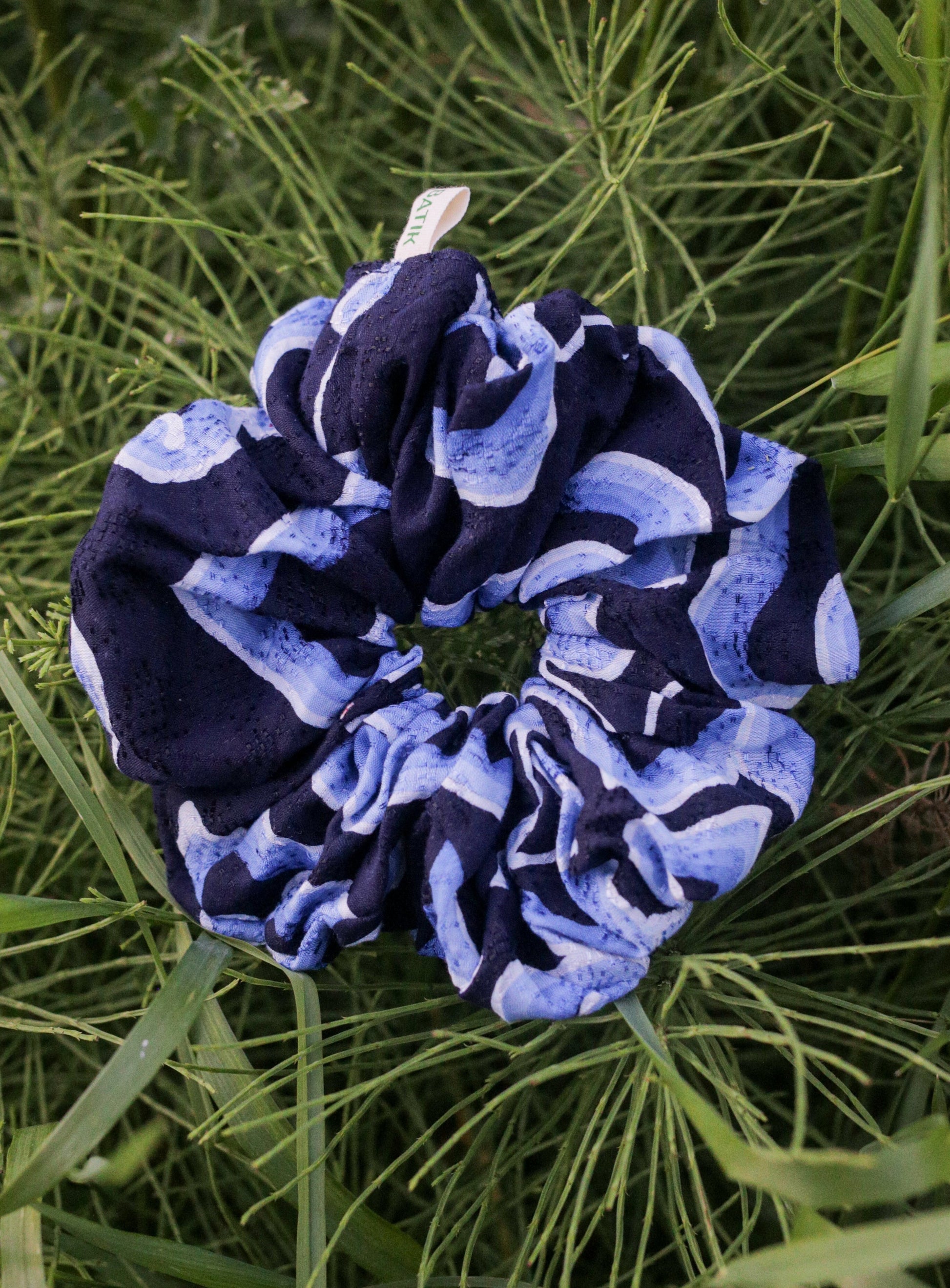 Navy and light blue batik scrunchie on green grass